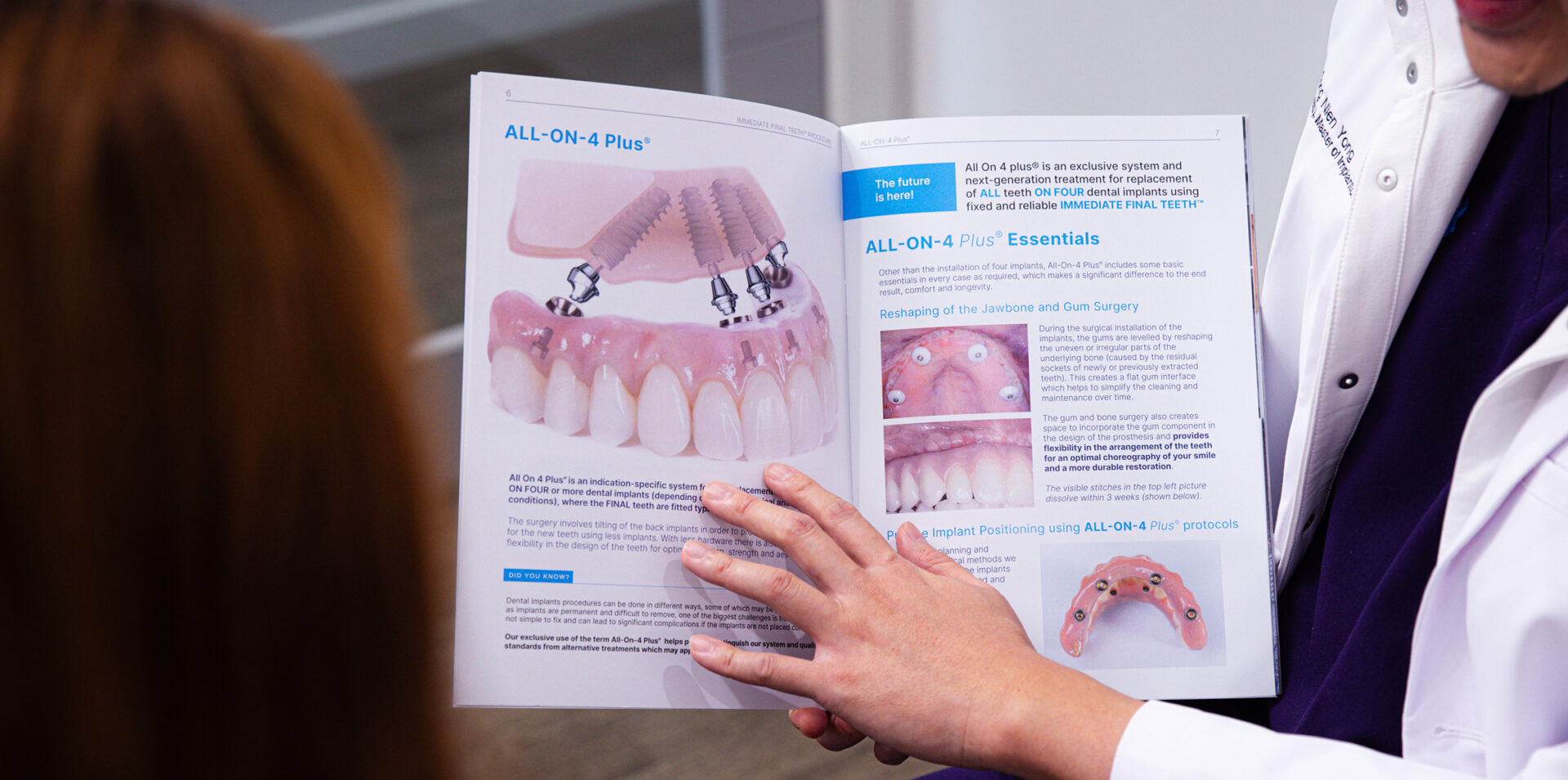Dentist explaining the All-On-4 Plus dental implant procedure using a brochure at New Gisborne Dental House